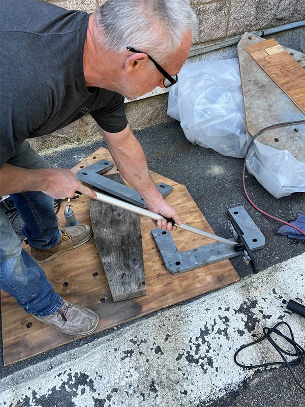 Photo of man restoring a floor in the Hall